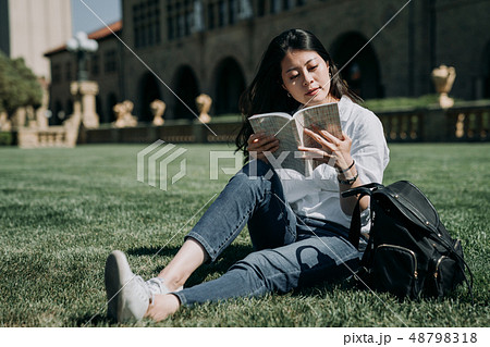 asian student reading book at school park asian student reading book at school park 48798318