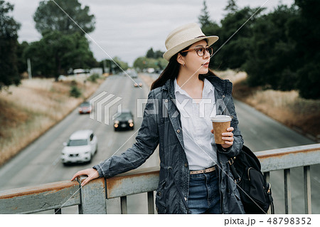 relaxing woman stop while crossing walkway bridge 48798352