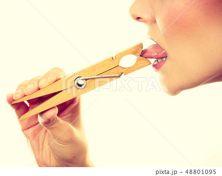 Blonde woman having tongue in clothespin 48801095