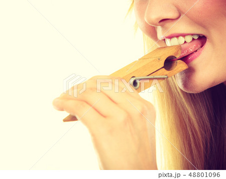 Blonde woman having tongue in clothespin 48801096