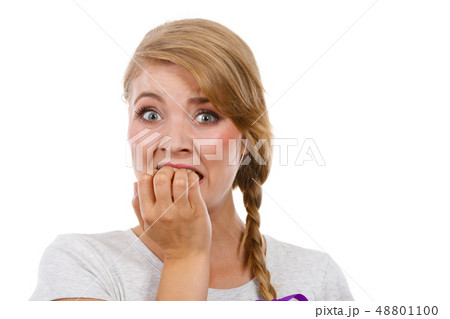 Scared, stressed woman biting her nails 48801100