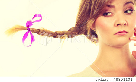 Sad teenage girl in windblown braid hair Sad teenage girl in windblown braid hair 48801101