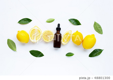 Fresh lemon with lemon essential oil on white Fresh lemon with lemon essential oil on white 48801300