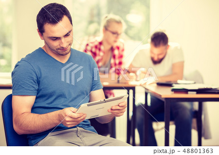 Male student with tablet in front of her classmates 48801363