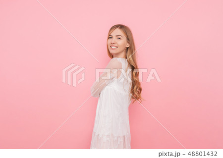 Happy girl with curled hair in a white dress 48801432