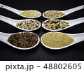 variety of grains on  spoons over black 48802605