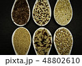 variety of grains on  spoons over black 48802610