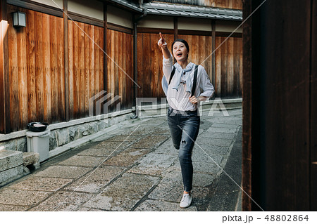 girl excited pointing finger to destination 48802864