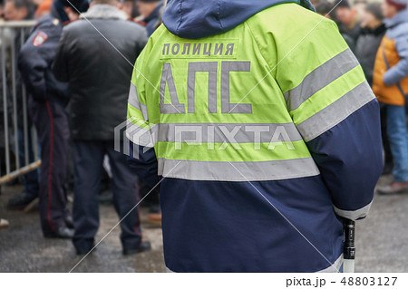 Back of a russian traffic policeman wearing his uniform jacket Back of a russian traffic policeman wearing his uniform jacket 48803127
