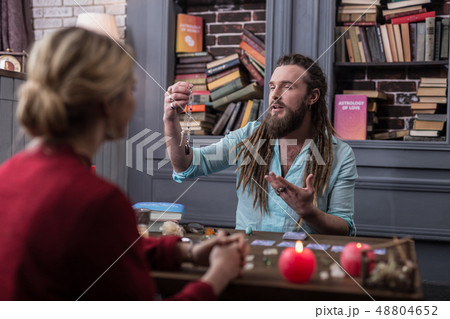 Positive bearded man presenting a special amulet 48804652