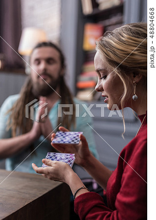 Nice young blonde woman shuffling the cards 48804668