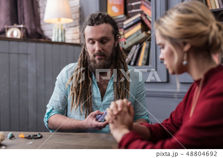 Nice serious fortune teller looking at the cards 48804692