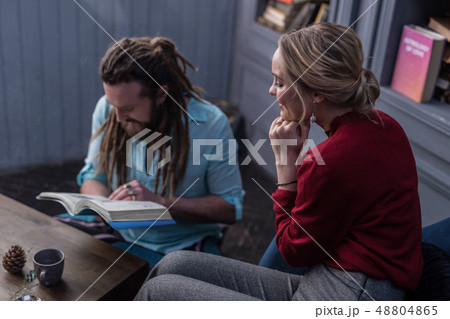 Positive delighted blonde woman touching her chin 48804865