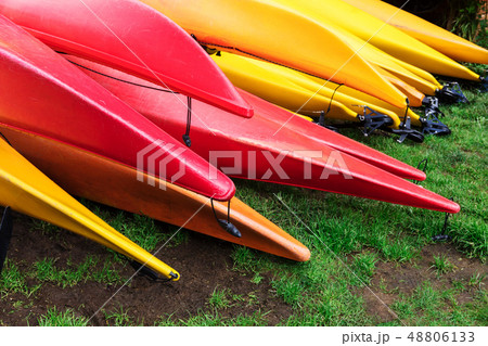 kayaks lie on green lawn 48806133