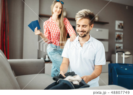 Husband and wife packing baggage for vacation Husband and wife packing baggage for vacation 48807749