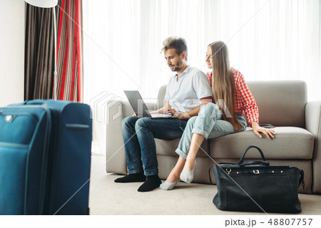 Couple looks on laptop screen, fees on journey Couple looks on laptop screen, fees on journey 48807757
