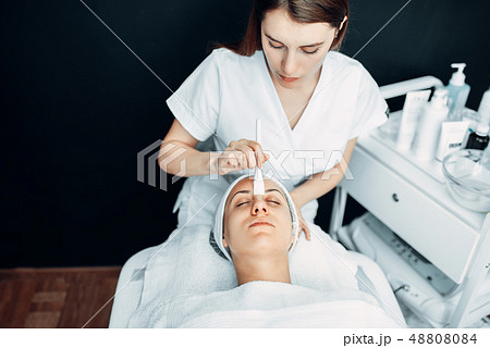 Beautician makes rejuvenation procedure to patient Beautician makes rejuvenation procedure to patient 48808084