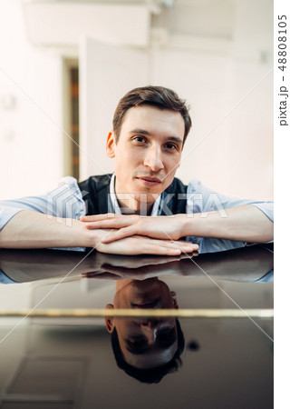Pianist at the piano, perfectly polished surface 48808105