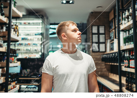 Male customer choosing drinks in supermarket 48808274