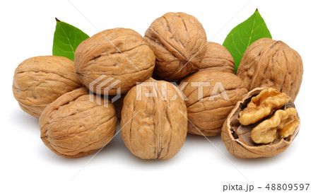 Walnut and cracked walnut with leaf isolated Walnut and cracked walnut with leaf isolated 48809597
