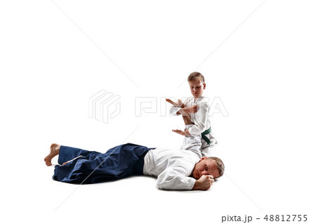 Man and teen boy fighting at aikido training in martial arts school 48812755