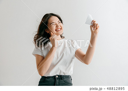 Young woman with a surprised expression won a bet Young woman with a surprised expression won a bet 48812895