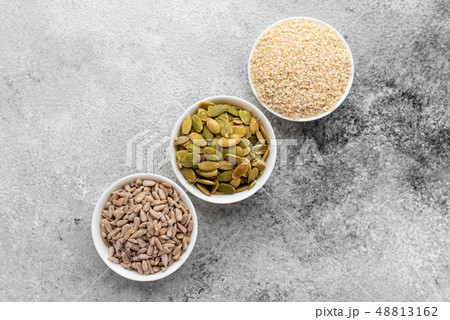 Assortment of nuts in white saucers  48813162