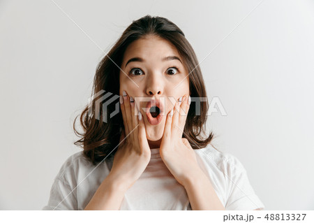Beautiful woman looking suprised 48813327