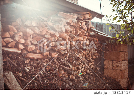 Stack of firewood under the roof near the house Stack of firewood under the roof near the house 48813417