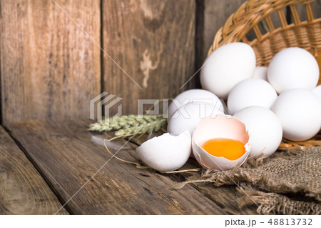White eggs from the basket and broken egg 48813732
