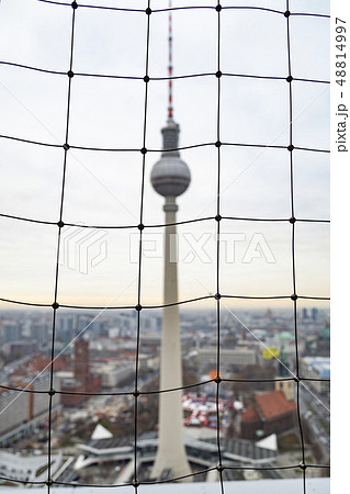 View of TV tower Fernsehturm through mesh fencing View of TV tower Fernsehturm through mesh fencing 48814997