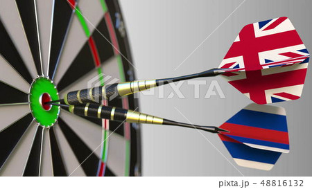 Flags of the United Kingdom and Russia on darts hitting bullseye of the target. International Flags of the United Kingdom and Russia on darts hitting bullseye of the target. International 48816132