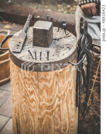 Metalworking tools of blacksmith. The hammer and the anvil and other tools outdoor green grass 48816423