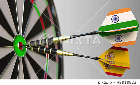 Flags of India and Spain on darts hitting bullseye of the target. International cooperation or Flags of India and Spain on darts hitting bullseye of the target. International cooperation or 48818922