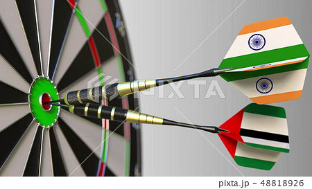 Flags of India and the UAE on darts hitting bullseye of the target. International cooperation or 48818926