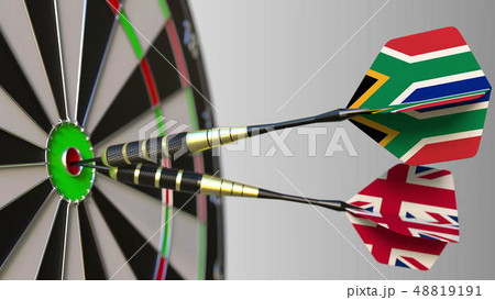 Flags of South Africa and the United Kingdom on darts hitting bullseye of the target. International Flags of South Africa and the United Kingdom on darts hitting bullseye of the target. International 48819191