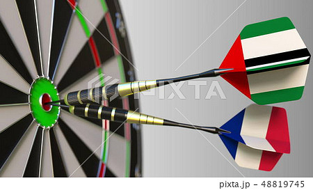 Flags of the UAE and France on darts hitting bullseye of the target. International cooperation or Flags of the UAE and France on darts hitting bullseye of the target. International cooperation or 48819745