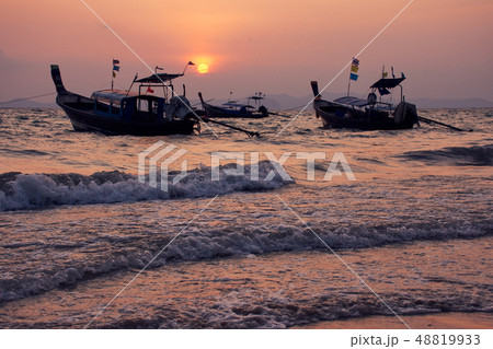 long-tailed boat and sunset at Khlong Muang Beach 48819933