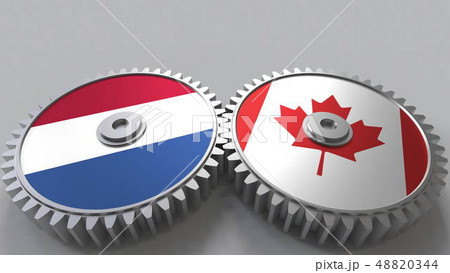 Flags of the Netherlands and Canada on meshing gears. International cooperation conceptual 3D 48820344