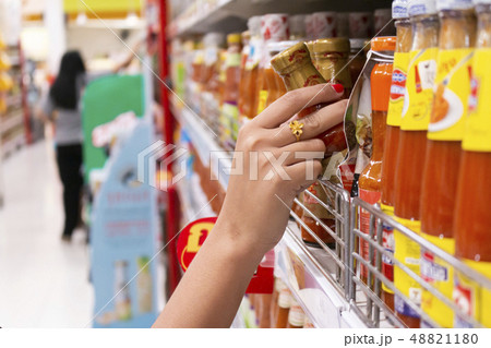 Closeup of female shopper picking products from 48821180