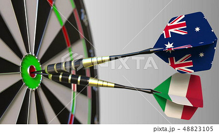 Flags of Australia and Italy on darts hitting bullseye of the target. International cooperation or 48823105