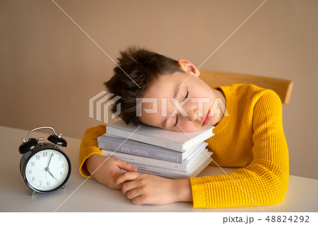 Little boy sleeping over books. Tired schoolboy studying in home. Little boy sleeping over books. Tired schoolboy studying in home. 48824292