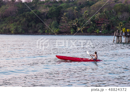 Women tourists wear bikini set kayaking in sea. 48824372