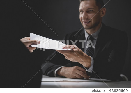Businessman giving money in white envelope to 48826669