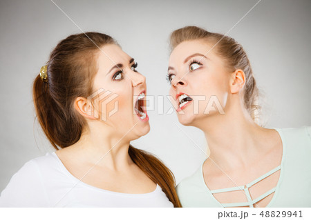 Two agressive women having argue fight 48829941
