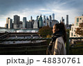Young woman standing on riverside in Brooklyn 48830761
