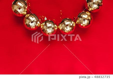 Golden balls on red background with place 48832735