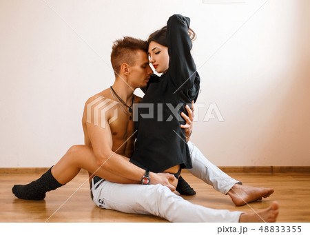 Young Caucasian couple lying on the floor  48833355