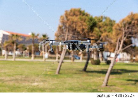 A drone with digital camera flying in the park 48835527