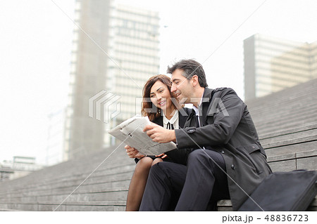 engineers male and female reading article about company in  48836723